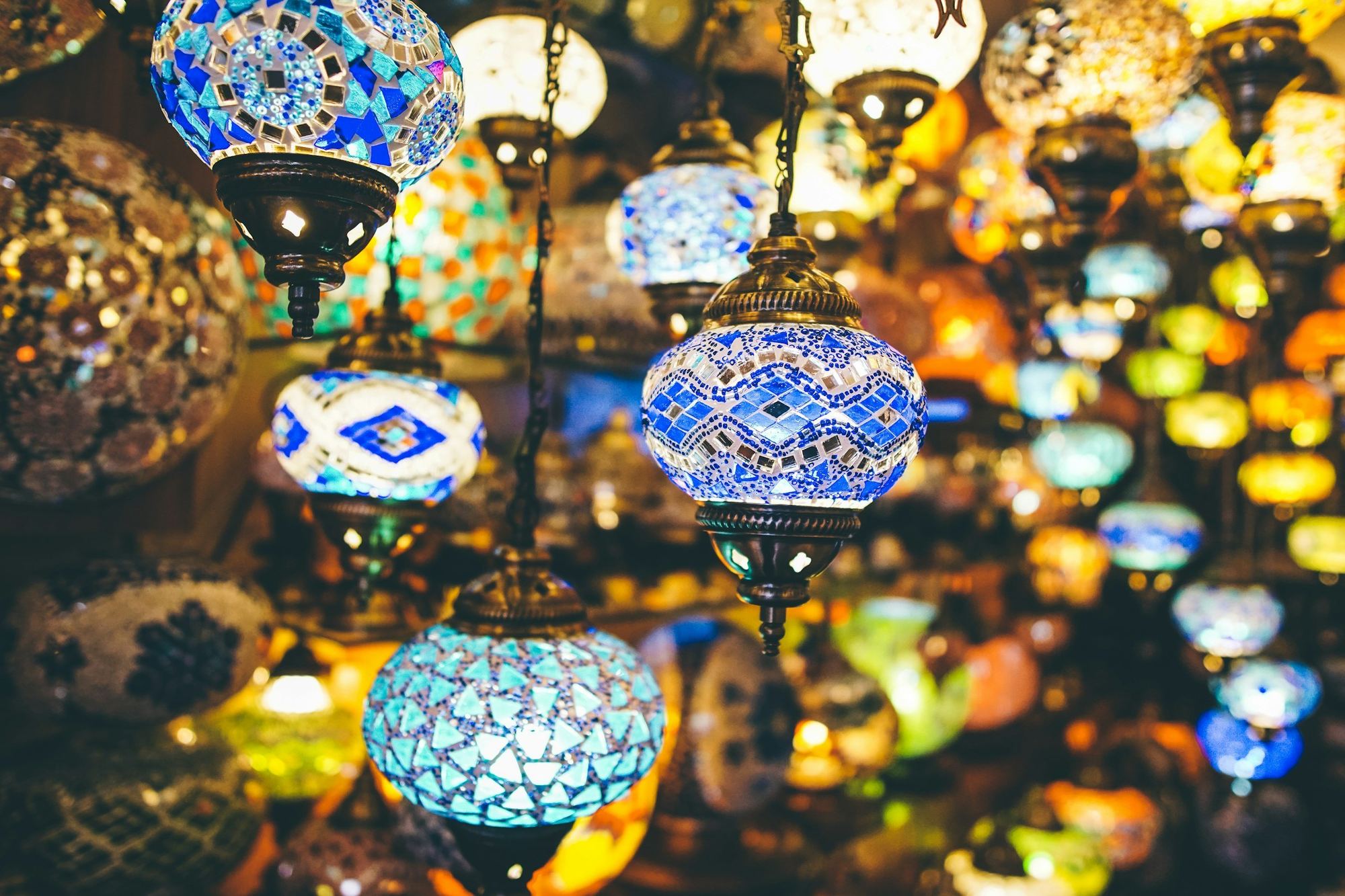 Hanging mosaic-glass lanterns glowing in warm light